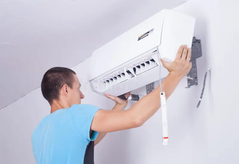 Certified technician installing split AC unit in Delhi NCR — EZAC Service